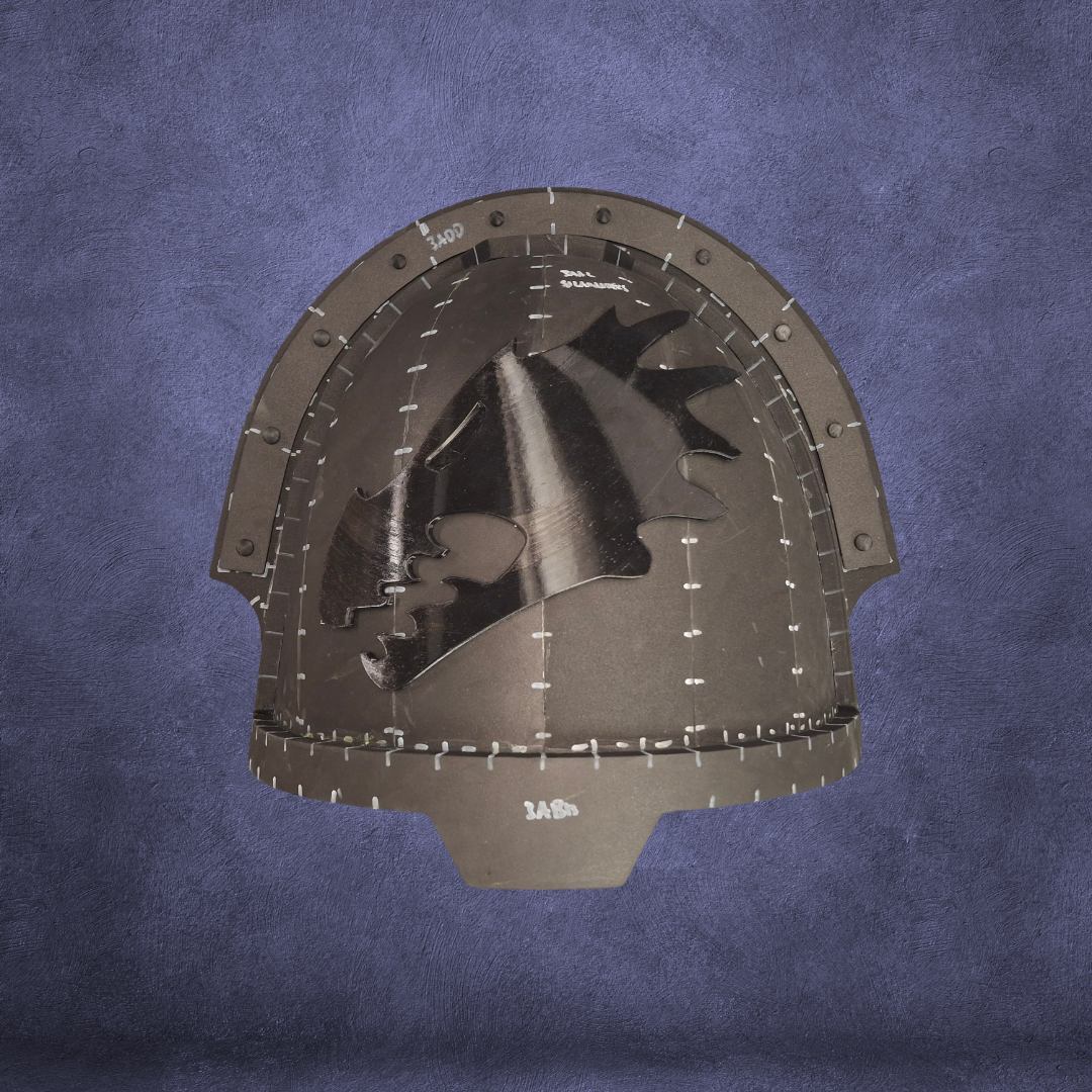 A black medieval-style helmet featuring a dragon head design and visible stitching is centered on a textured purple background, evoking the look of the V.10 Fire Lizards Shoulder Detail (3D Print | Files Only).