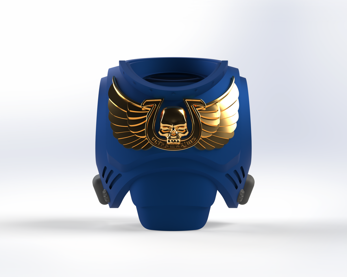 The V.10 Blueberry Warriors Chest Detail (3D Print | Files Only) showcases a blue armored chestplate adorned with a gold winged skull emblem encircled by a horseshoe-shaped border on a clean white background, inspired by the Tactical Chest Remaster Pattern and ideal for enhancing 3D-printable Galactic Warriors models.