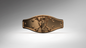 A metallic bronze belt buckle featuring a central horse skull and crossed bones motif, flanked by decorative studs, shown on a neutral gray gradient background.