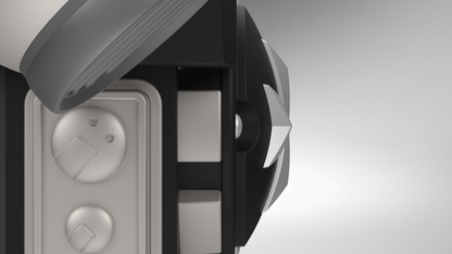 Close-up of the V.10 Grim Paladins Backpack Cover Detail V.1 (3D Print | Files Only), featuring a circular star-shaped component, a partial metallic lid, and two dials or buttons on a gray panel—elements that echo the intricate design language of Tactical Grim Paladins gear. The background is gradient gray.