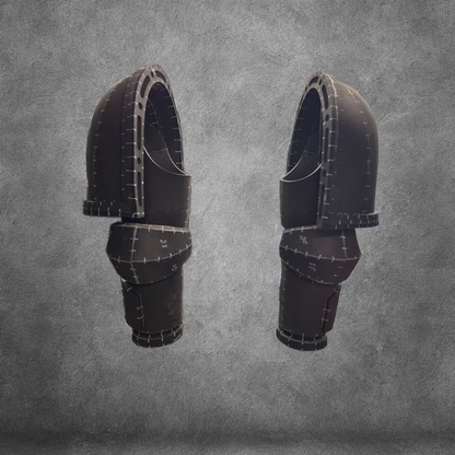 Two black, segmented, futuristic armor pieces—ideal for arms or legs—float against a textured gray background, displaying intricate seams and sharp geometric patterns. Perfect as an EVA foam template for your next cosplay or crafting project, this digital download is inspired by Galactic Warriors arms design and features the V.10 Tactical Arms Pattern.