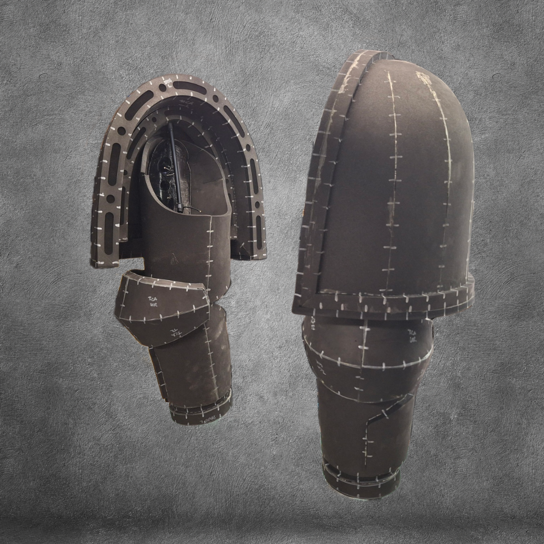 Two dark, segmented V.10 Tactical Arms Pattern pieces with white stitching and scale markings are displayed upright against a gray textured background. The arms feature a mechanical, flexible, and futuristic design—ideal as inspiration for a digital download or EVA foam template.