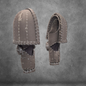 Two views of the V.10 Tactical Arms Pattern medieval-style helmet, crafted from an EVA foam template with visible seams, construction lines, and markings, are displayed against a textured gray background. The helmet appears unfinished, highlighting its edges and assembly process.