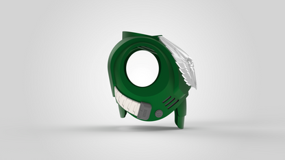 A green, circular V.10 Gloomy Celestials V.2 Chest Detail (3D Print | Files Only) featuring metallic wing-like accents on one side, white panels evoking the design of a Galactic Warriors chest, and two short legs—displayed against a plain light background.