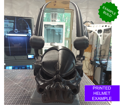 A black fantasy helmet—named the Midnight Rulers Helmet (3D Print | Files Only)—with prominent horn-like structures rests on a workbench. In the background, a 3D printer and various tools can be seen. Text identifies it as an example build, highlighting the printed helmet as an ideal showcase of what can be created using the digital download files.