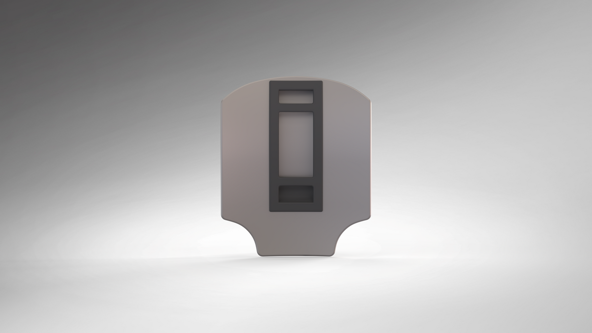 A metallic, shield-shaped object with a central rectangular black design is displayed against a smooth gray gradient background, evocative of the V.10 Edge Warden V.1 Hip Plate Pattern and ideal as a 3D-printable hip plate for futuristic armor builds.