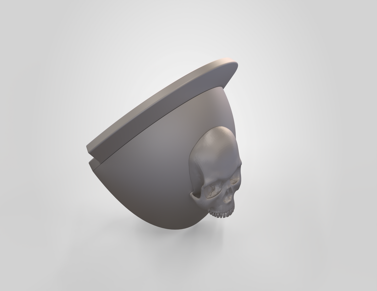 A 3D-rendered gray model shaped like a partial bowl or helmet with a flat rim and a realistic human skull integrated into its curved surface, the V.10 Knee Skull Detail V.1 (3D Print | Files Only) is presented against a plain light background. Designed as a 3D printable knee accessory, this piece offers both bold aesthetics and functional utility.