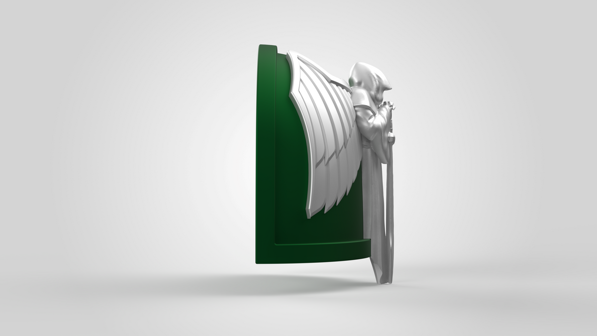 A green and silver shield featuring a raised design of a winged, armored figure wielding a sword—echoing the look of the V.10 Gloomy Celestials V.1 Shoulder Detail (3D Print | Files Only)—displayed from the side against a plain light background, ideal as a digital download for your Galactic Warriors 3D print projects.
