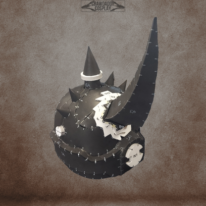 A black Mortis Sentry Helmet with spikes, a prominent curved horn, and distinctive white gear-like details is displayed against a brown textured background. Perfect for cosplay, the helmet showcases visible seams and a pointed top spike. This digital download provides an EVA foam template of the Mortis Sentry Helmet for convenient home crafting.