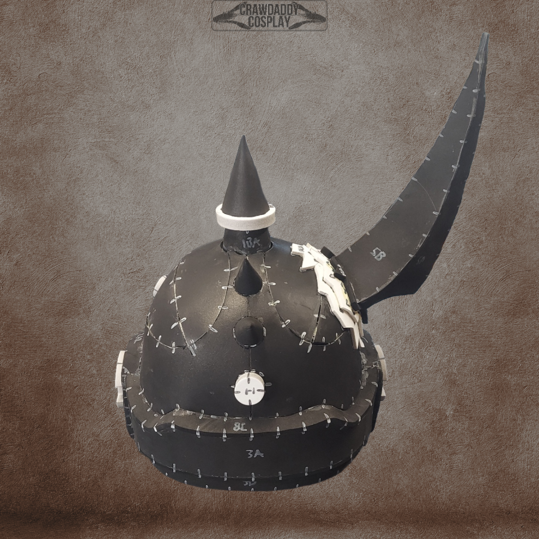 A black, handmade Mortis Sentry Helmet cosplay helmet with white stitch lines, featuring a tall front spike and a long curved crest on the right side, is displayed against a textured brown background. Created using an EVA foam helmet template and offered as a digital download. The text “CRAWDADDY COSPLAY” appears above.