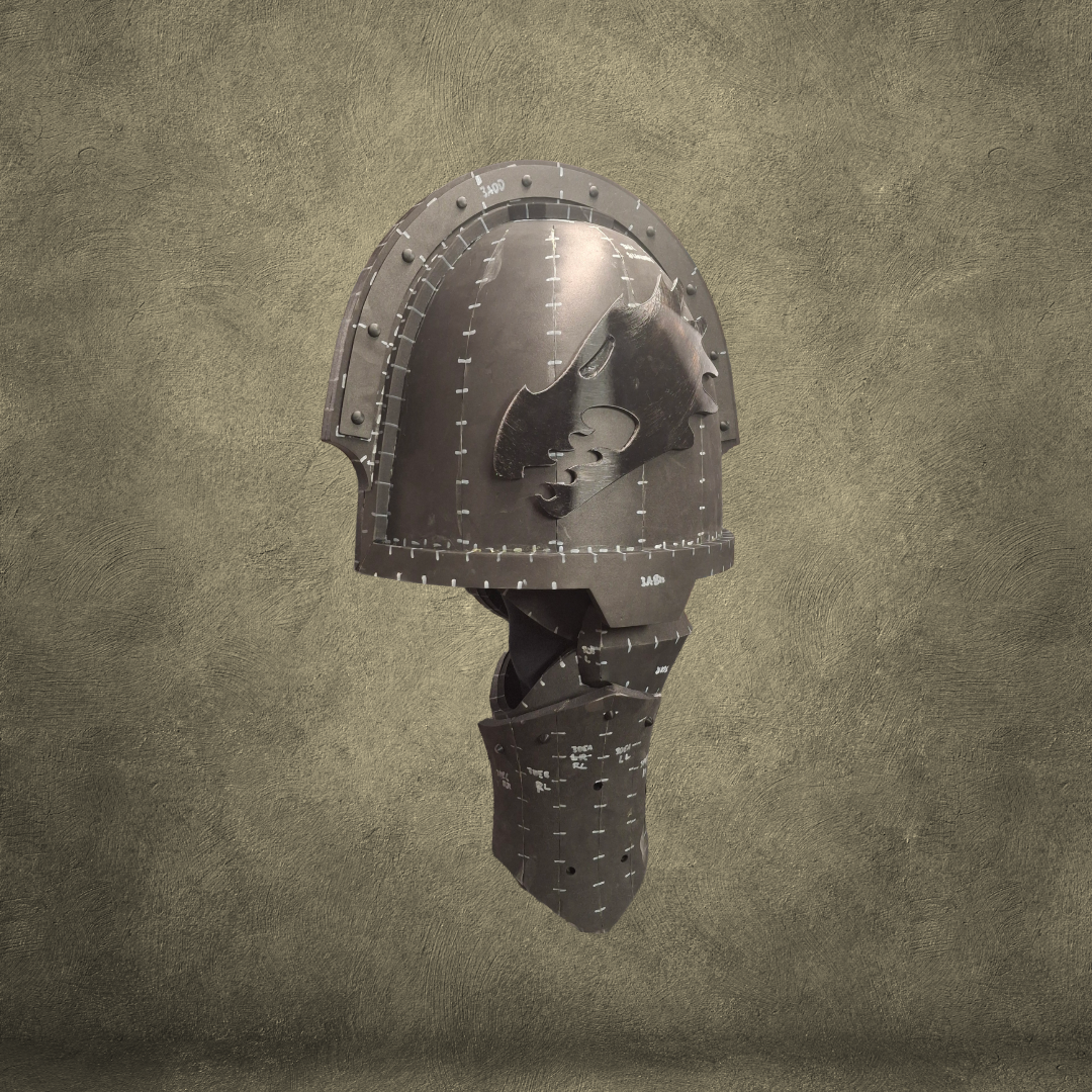 A medieval-style metal helmet with a visor and face guard, displayed against a textured, brownish background. The helmet features visible seams and stitches, giving it a patchwork look characteristic of the V.10 Edge Warden Arms Pattern design.