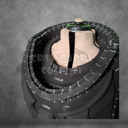 Black tire with tread pattern on a gray background
