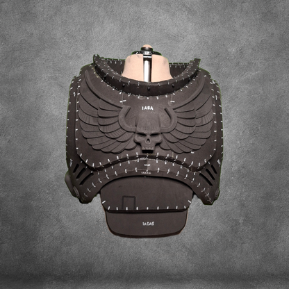 Showcased on a torso mannequin against a gray textured backdrop, the V.10 Tactical Chest Pattern features black, foam-crafted Galactic Warriors armor adorned with a bold winged skull emblem. White stitching lines highlight the design details, and you can recreate this impressive look using the digital download EVA foam template.