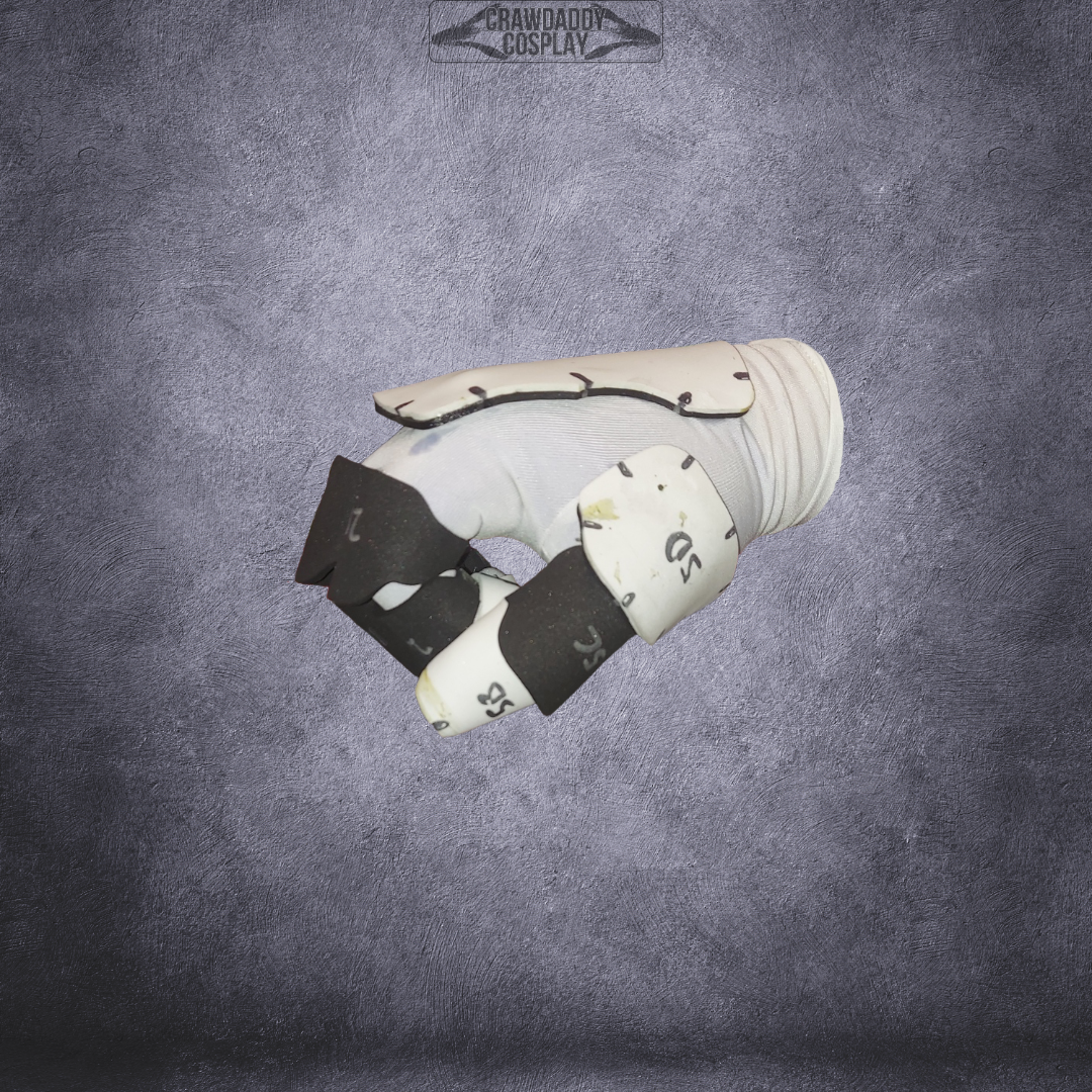 A white, padded, glove-like hand prop with black foam fingertips—crafted using an EVA foam template—is displayed against a textured gray background with a CRAWDADDY COSPLAY watermark at the top. Perfect for completing your Galactic Warriors Universal Glove Pattern cosplay, this digital download includes all the detailed instructions you need.