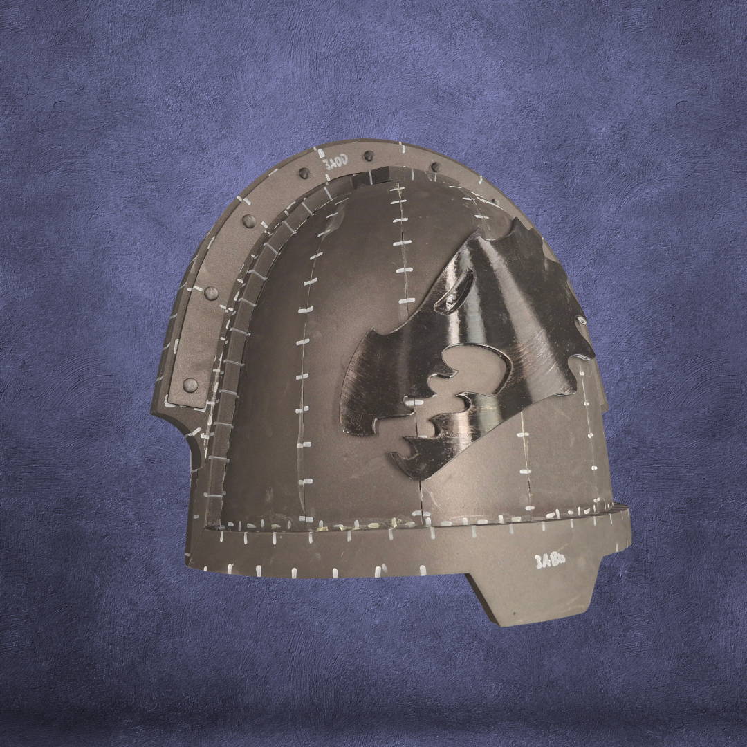 A metallic helmet with a black bear profile embossed on the side, set against a textured blue background. The helmet features visible rivets and stitched-like seam details, echoing the intricate craftsmanship found in the V.10 Fire Lizards Shoulder Detail 3D-printable designs available as digital download files.