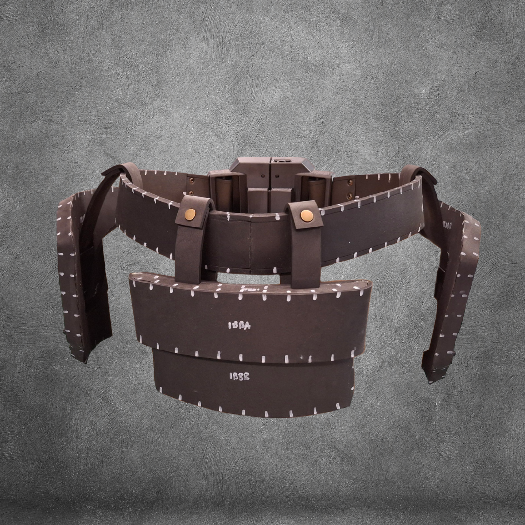 Introducing the V.10 Tactical Waist Pattern: a brown segmented foam armor belt featuring attached rectangular plates, silver rivet accents, and two prominent front panels—ideal for Galactic Warriors Waist costumes. This intricately detailed design is displayed against a textured gray background and offered as a digital download EVA foam template.