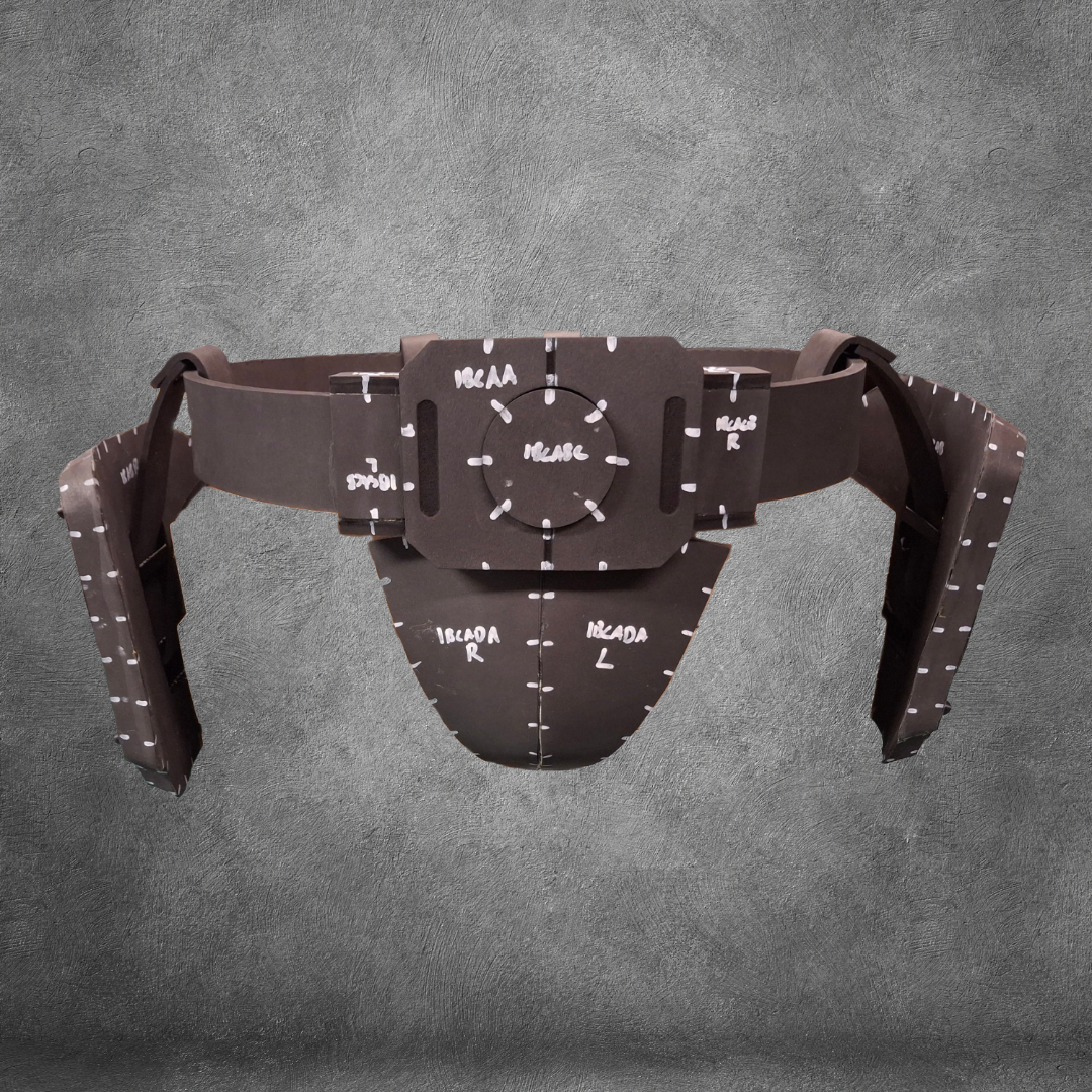 The V.10 Tactical Waist Pattern is a brown protective athletic cup and belt, inspired by the Galactic Warriors Waist, featuring handwritten white markings and measurement labels, displayed on a gray textured background.