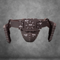 The V.10 Tactical Waist Pattern is a brown protective athletic cup and belt, inspired by the Galactic Warriors Waist, featuring handwritten white markings and measurement labels, displayed on a gray textured background.