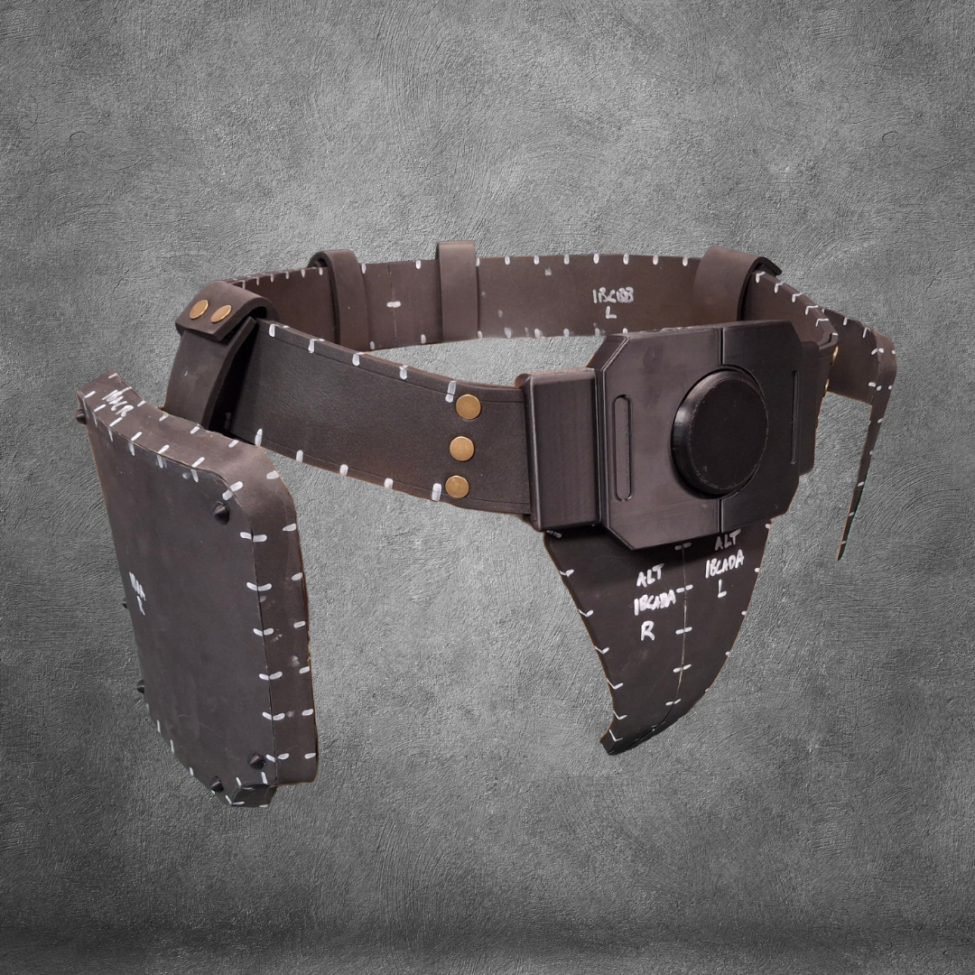A brown, futuristic utility belt—called the V.10 Tactical Waist Pattern—features padded panels, white measurement markings, and a round buckle, displayed on a gray textured background. This design is available as an EVA foam template digital download.